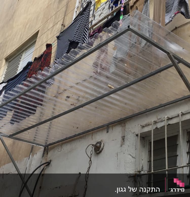 מסגרת מתכת עם כיסוי פלסטיק שקוף על קיר בניין